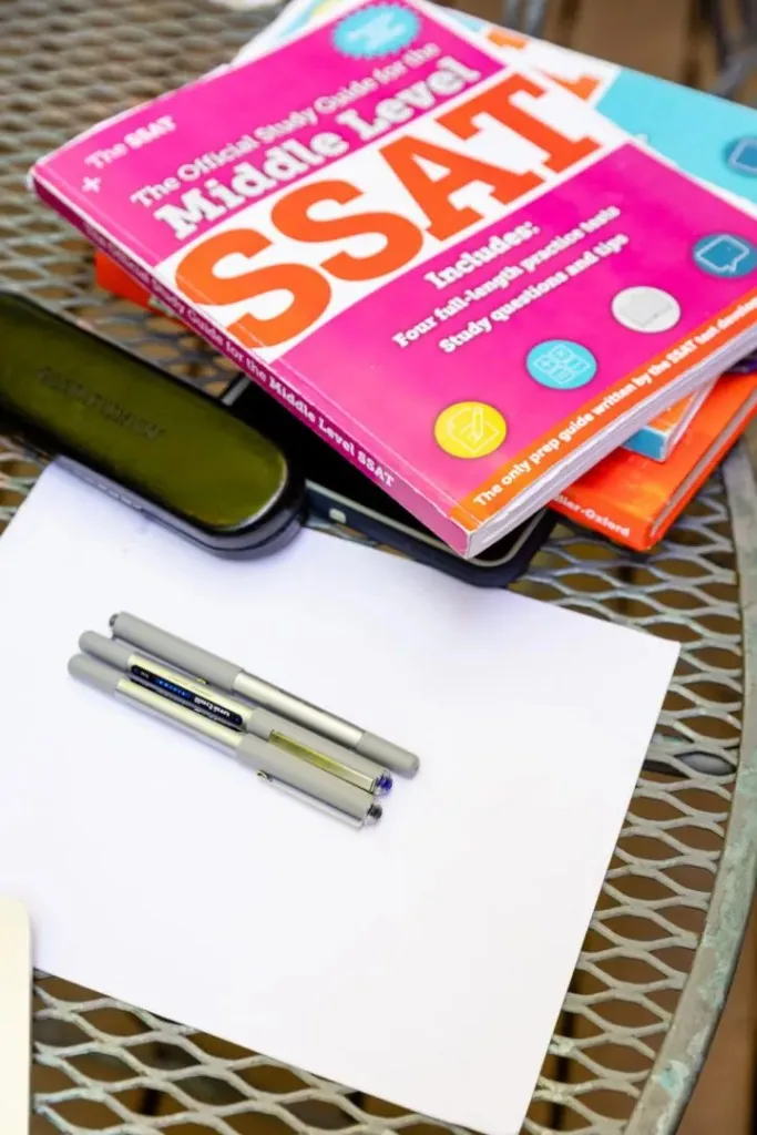 A book and pens on a tutor's desk
