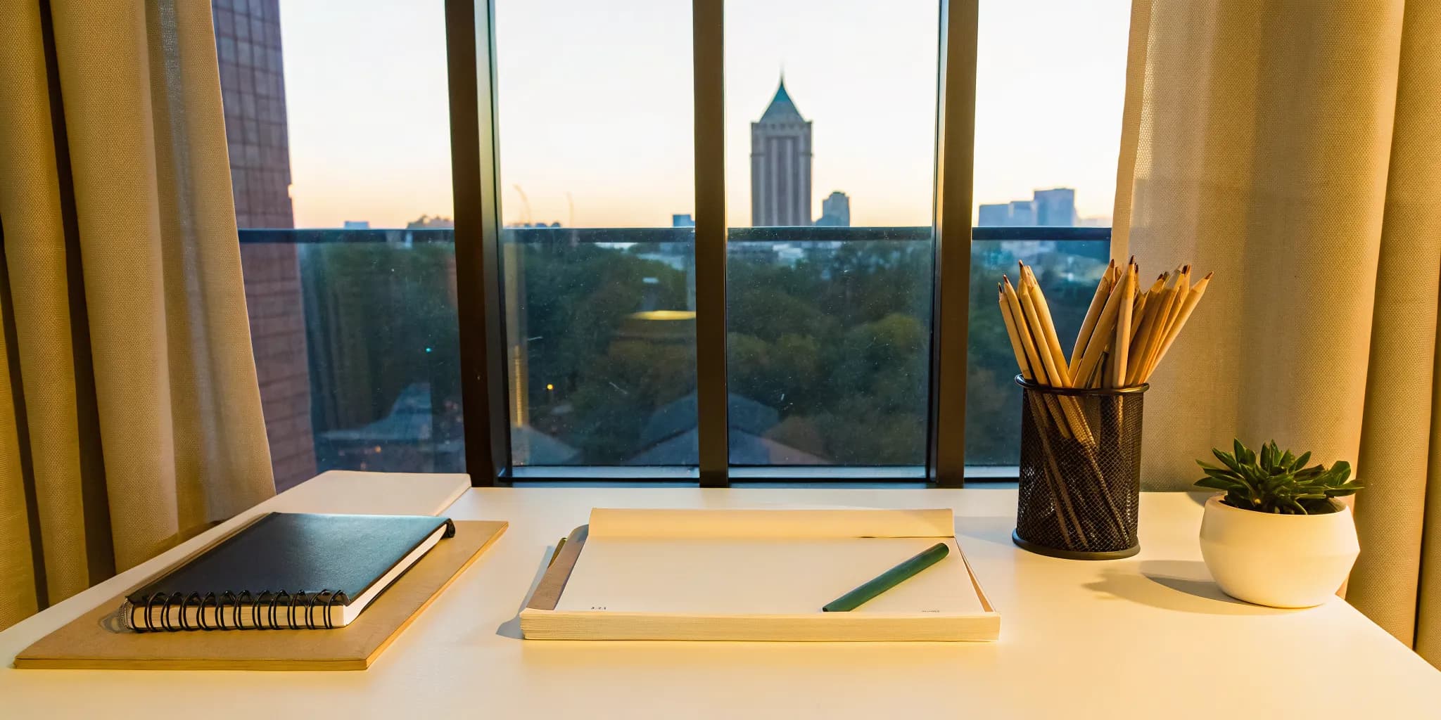 SSAT prep materials on a desk overlooking the Atlanta skyline.