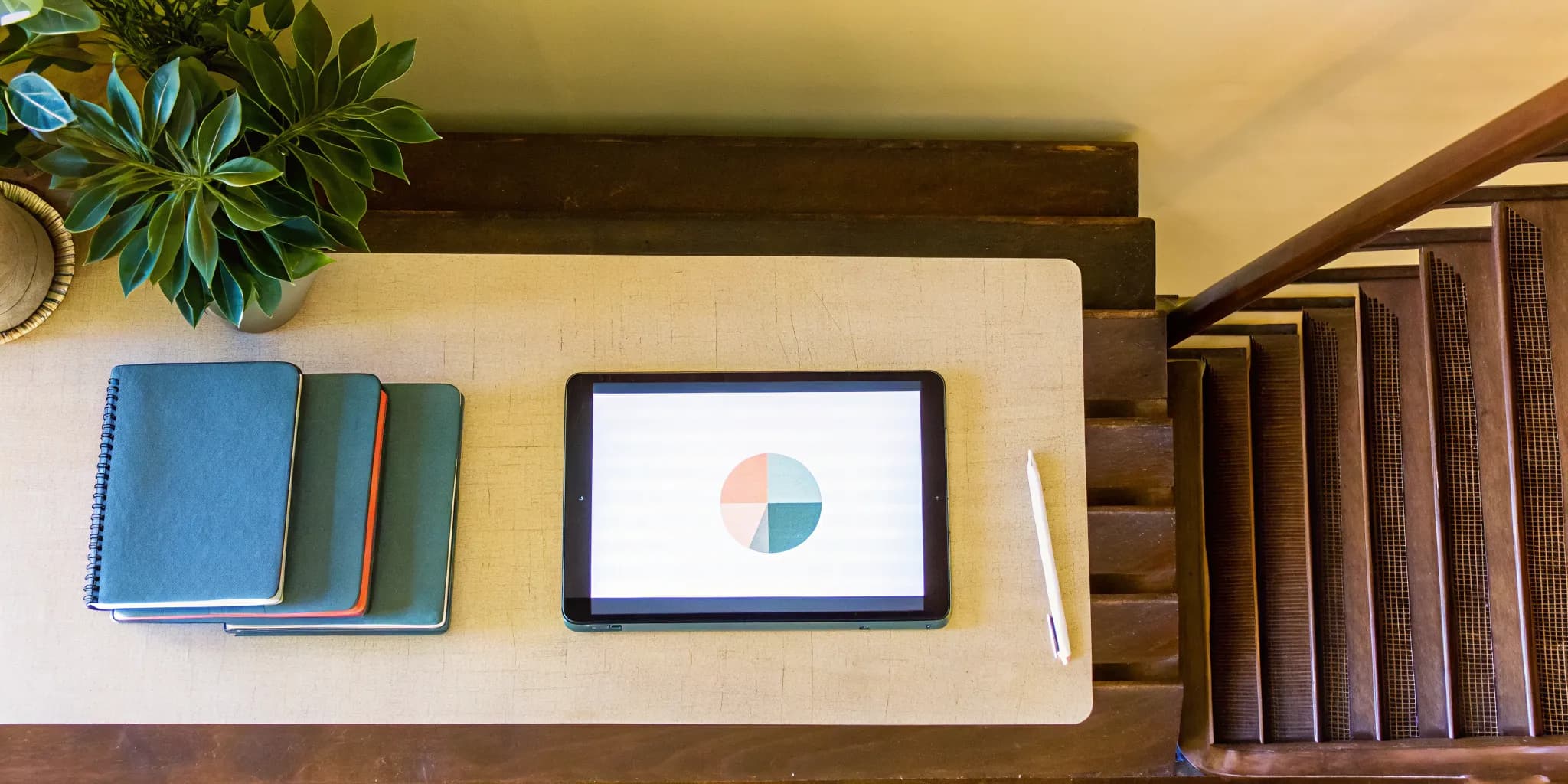 A study plan on a tablet with notebooks for how to improve an ACT English score.
